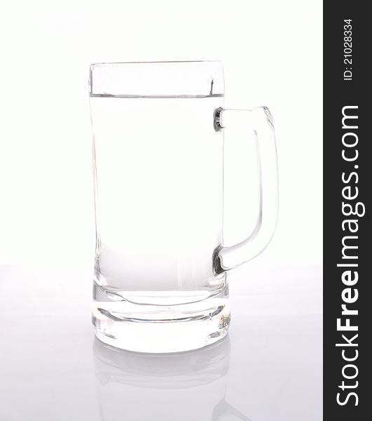 Attractive glass jug of water on white background.