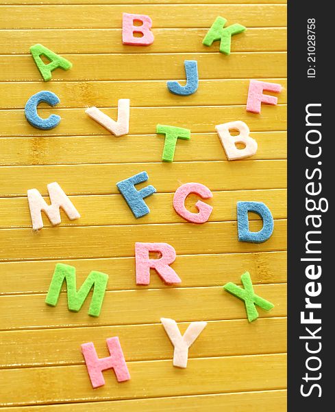 Color letters on wooden background