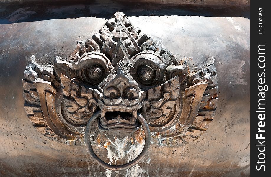 Lion head on a chinese copper censer surface. Lion head on a chinese copper censer surface.
