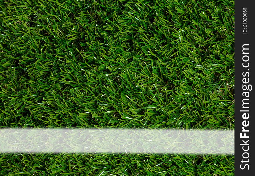 Sporting white lines on artificial green grass