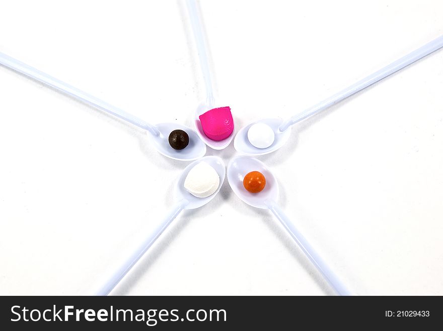 Top view of pills in spoon shot on white background.