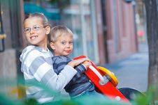 Happy Kids Ride On The Swings At The Playground Stock Photos