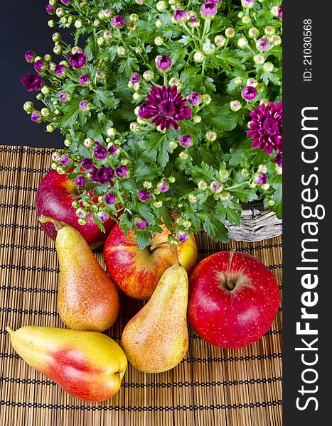 Basket with flowers and fresh fruits. Basket with flowers and fresh fruits