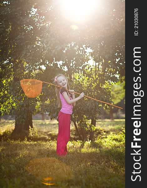 Little girl with butterfly net, in warm sun light. Little girl with butterfly net, in warm sun light