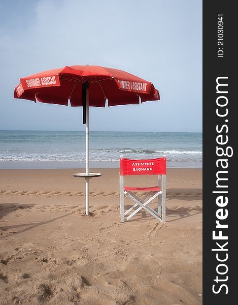 A lifeguard chair and umbrella. A lifeguard chair and umbrella