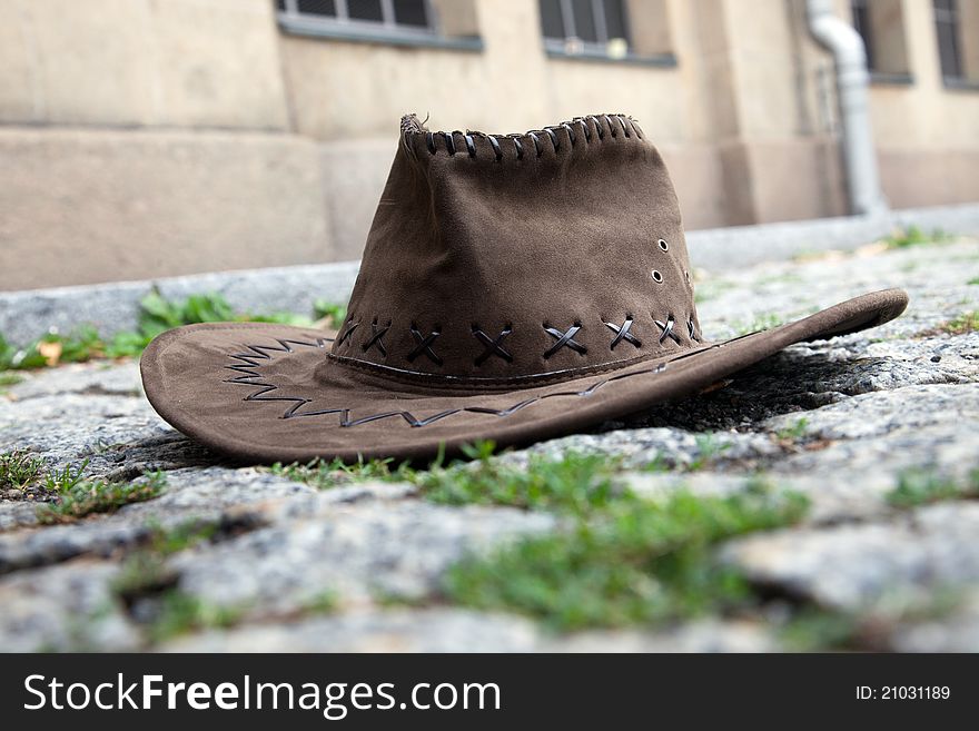 A leather hat on the cobbles street. A leather hat on the cobbles street