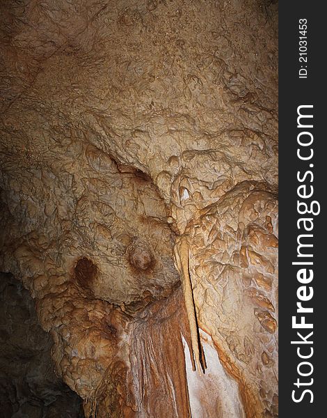 Stalactites in the cave on the wall, background. Stalactites in the cave on the wall, background.