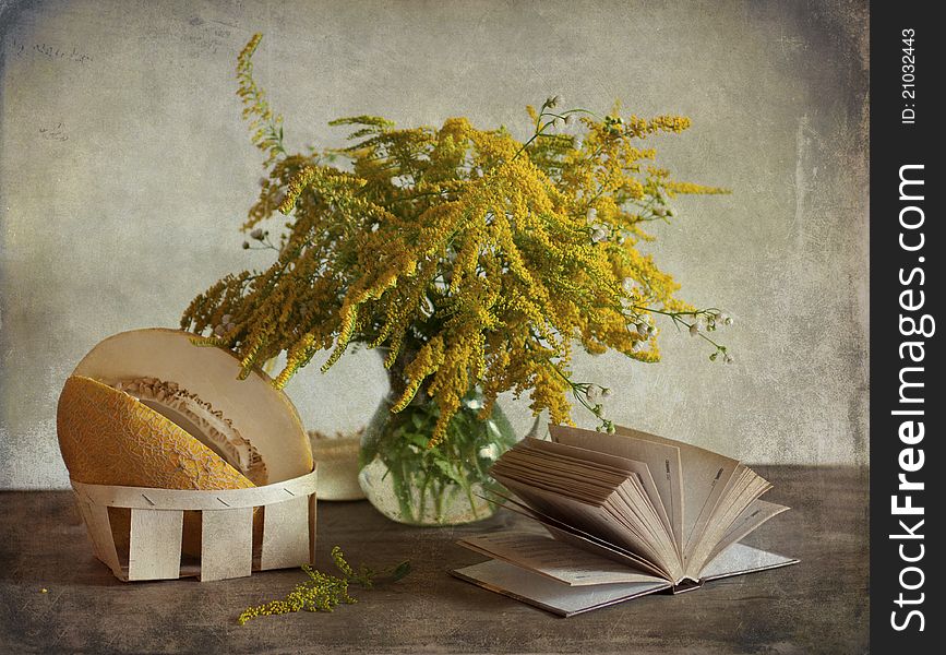 Still life with the yellow bouquet of flowers and melon. Still life with the yellow bouquet of flowers and melon