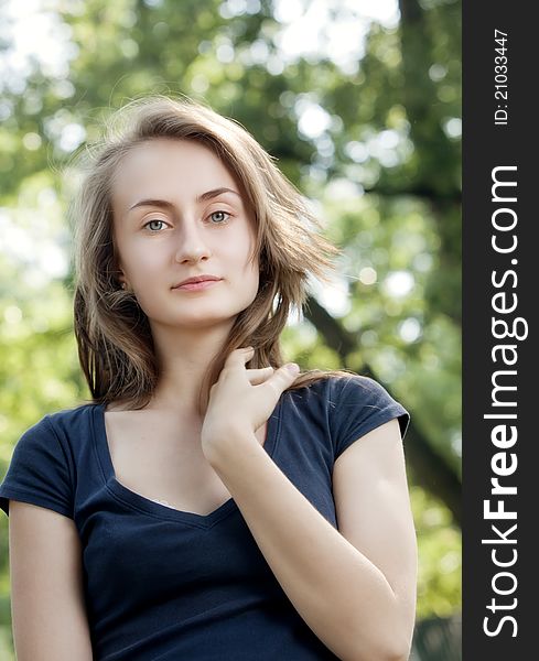 Portrait of a young woman on blured forest background