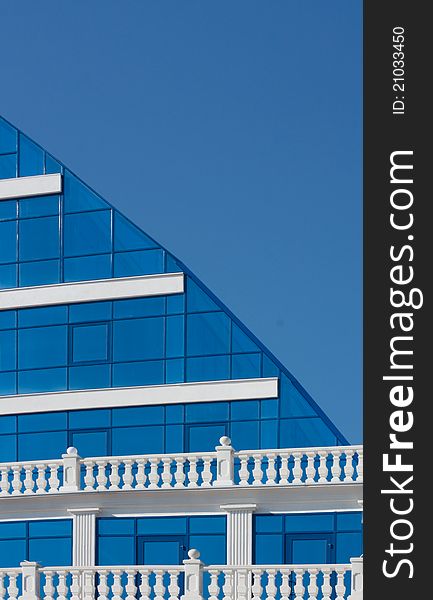 Part of modern building over blue sky