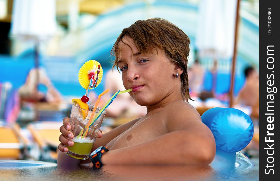 Boy Drinking Juice Through A Straw .