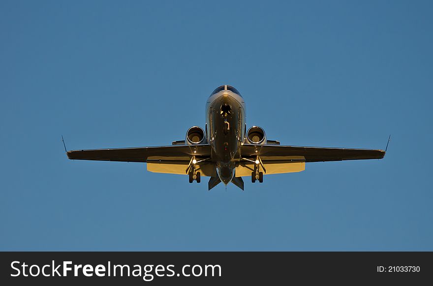 Aircraft landing at dusk, with orange sun and clouds. Aircraft landing at dusk, with orange sun and clouds