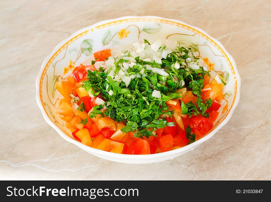Salad from cucumbers, tomatoes, pepper, an onions and parsley