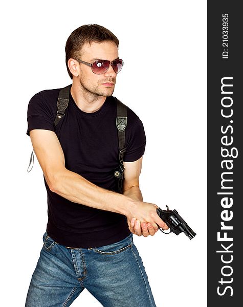 White male dressed in black on an isolated background wearing a shoulder holster armed with an revolver. White male dressed in black on an isolated background wearing a shoulder holster armed with an revolver