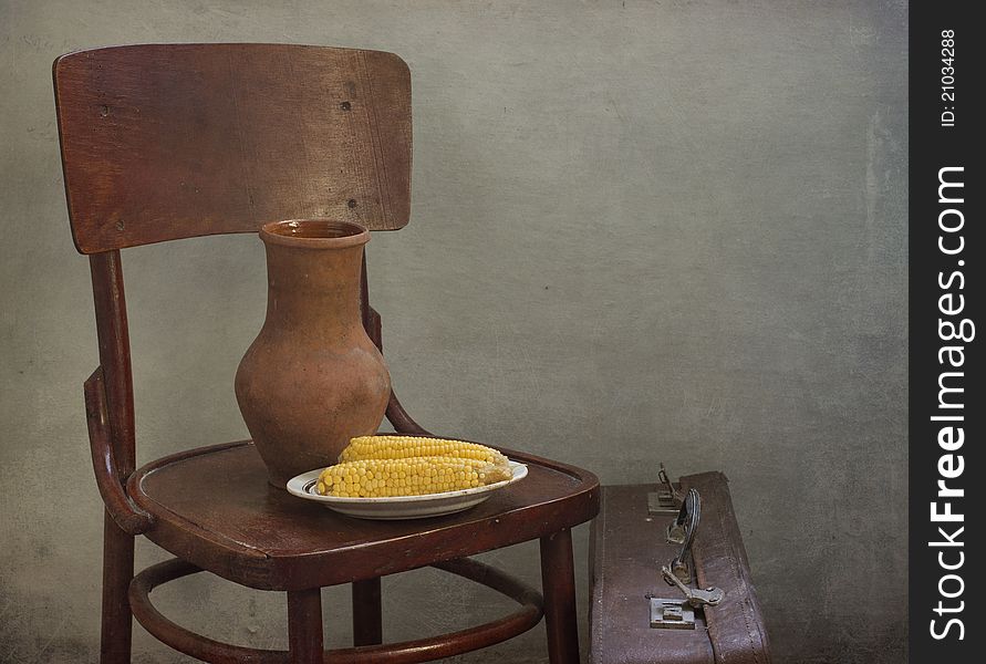 Jug and corn on a chair