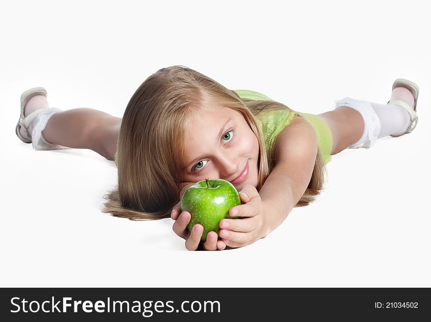 Little blond girl with green eyes holding a green apple. Little blond girl with green eyes holding a green apple