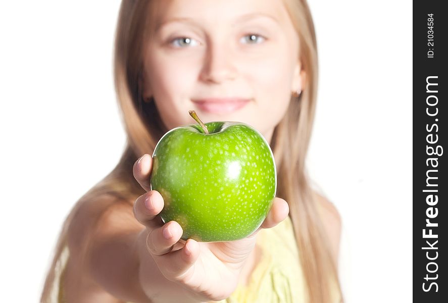 Little girl holding out a green apple isolated on white. Little girl holding out a green apple isolated on white