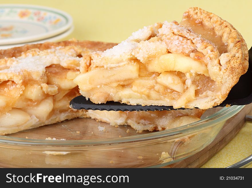 Closeup of a slice of apple pie on a pie cutter. Closeup of a slice of apple pie on a pie cutter