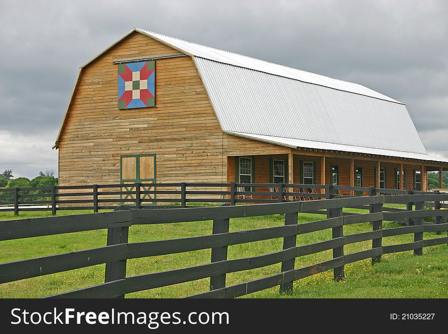 A barn with a quilt square over the door. A barn with a quilt square over the door