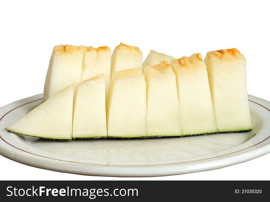 Sliced melon on the plate isolated over white background. Sliced melon on the plate isolated over white background