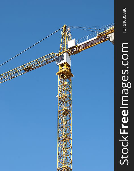 Yellow crane on blue sky background