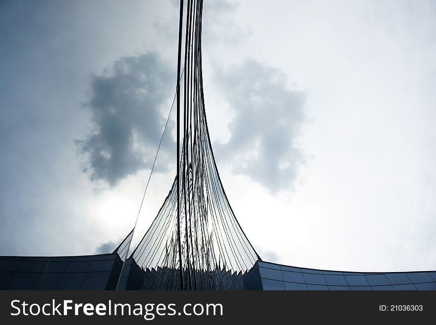 Curve arc glass structure reflecting the clear blue sky