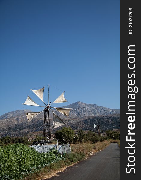 Wind turbine to power a water pump next to a pool of water