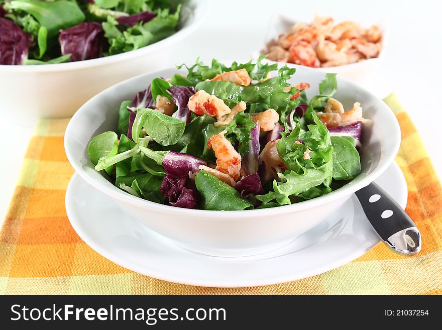 Mixed, colorful salad with crayfish on a white background. Mixed, colorful salad with crayfish on a white background