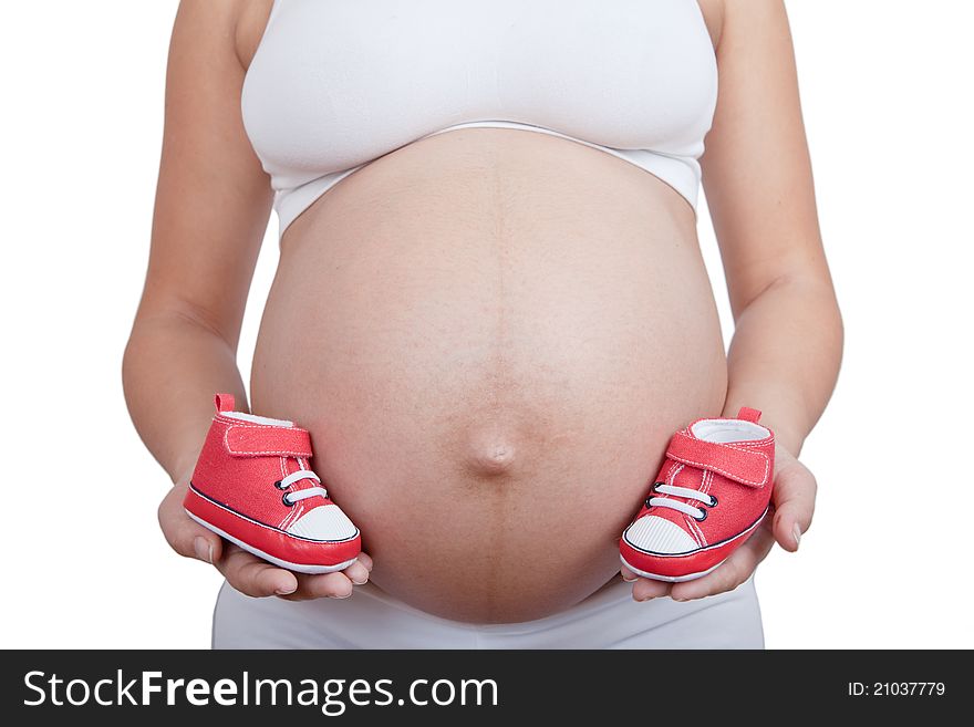 Pregnant woman hold in hand red baby boots isolated