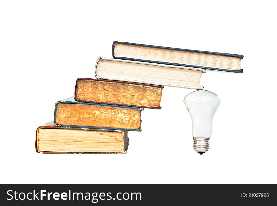 A lamp under the ancient books isolated on whith background