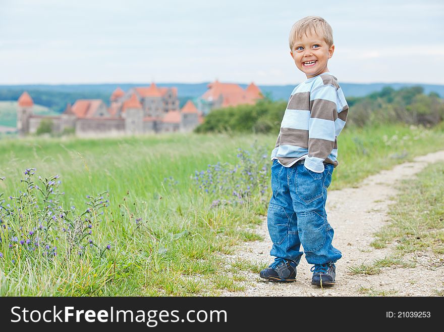 Young travelers. Cute little boy on a tour of European medieval castles. Vertical view