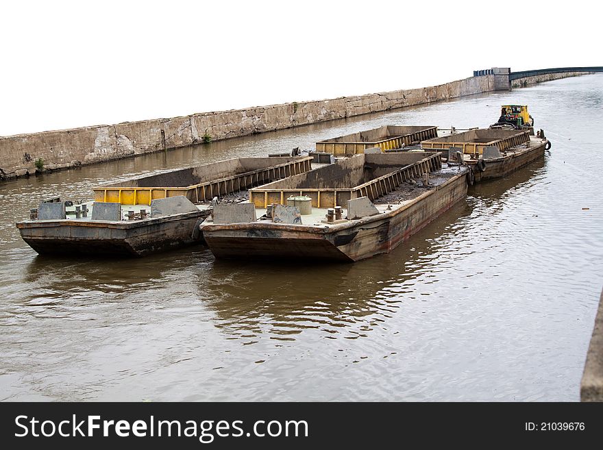 Yellow old tugboat on water