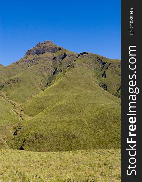 A peak in south africa's drakensberg mountains photographed on a sunny day with blue skies. A peak in south africa's drakensberg mountains photographed on a sunny day with blue skies