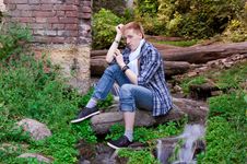 Young Human Is Siting Among Greenery Royalty Free Stock Image Young Human Is Siting Among Greenery Royalty Free Stock Image