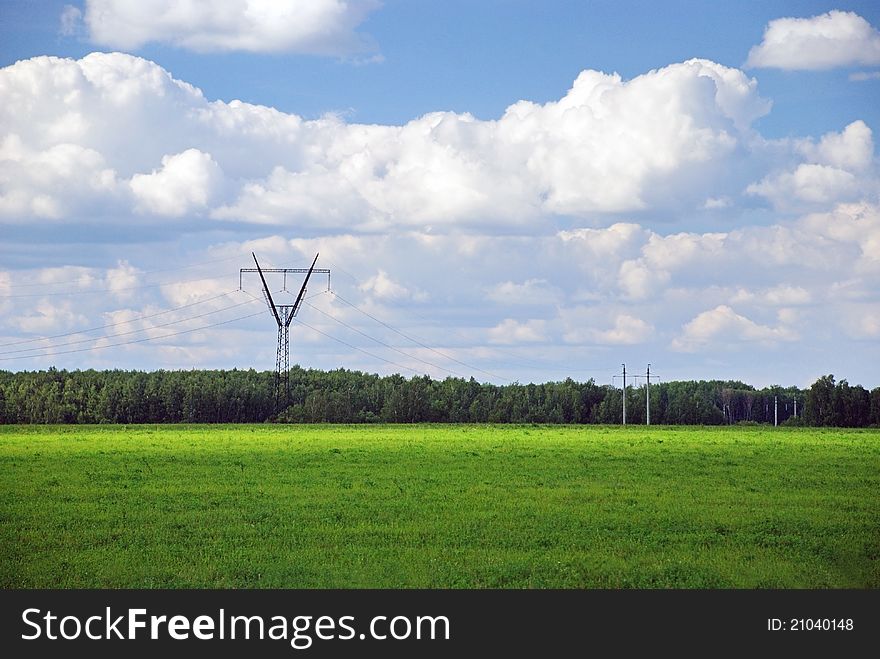 Power line in the green forest and field. Power line in the green forest and field