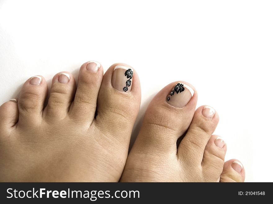 Pedicure with a flower pattern on a white background