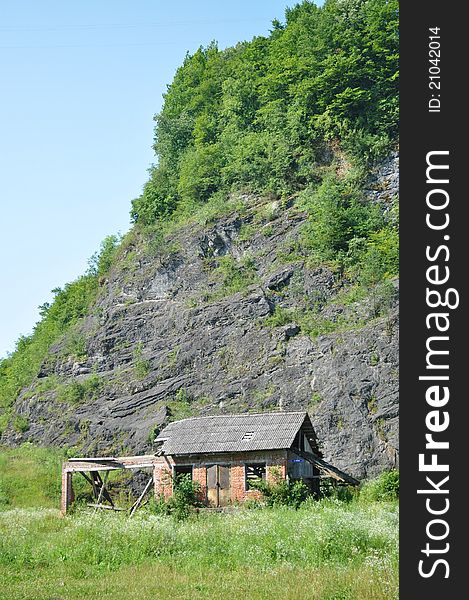 Mountain hut at base of tall mountain