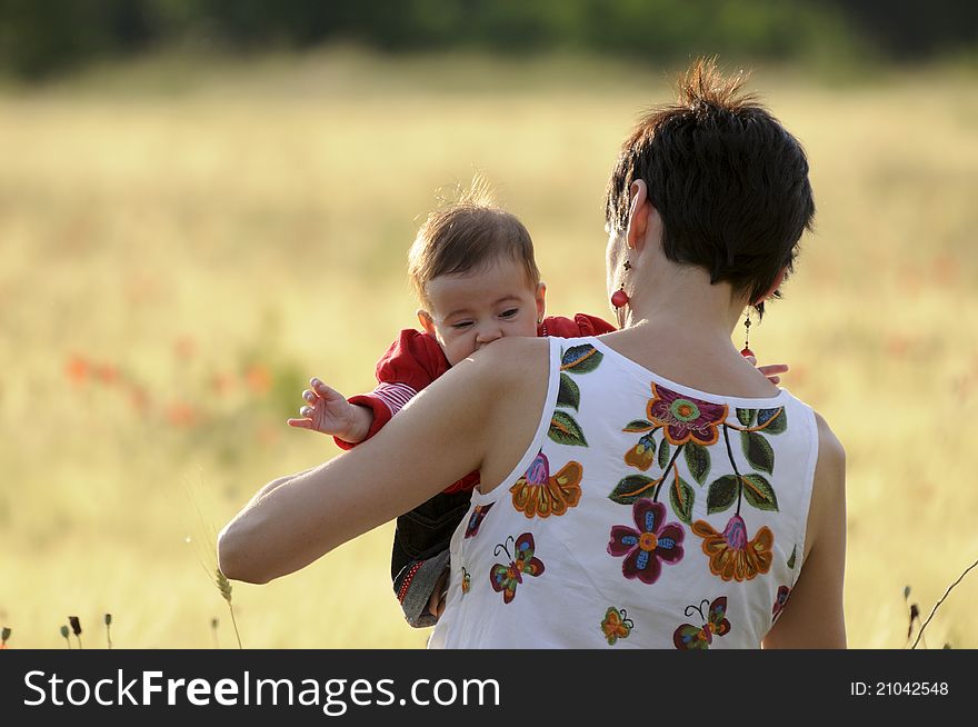 A mother with her daughter in a poppy field. A mother with her daughter in a poppy field