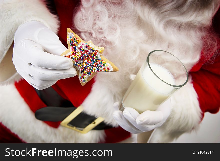 Santa holding cookie and glass of milk. Santa holding cookie and glass of milk