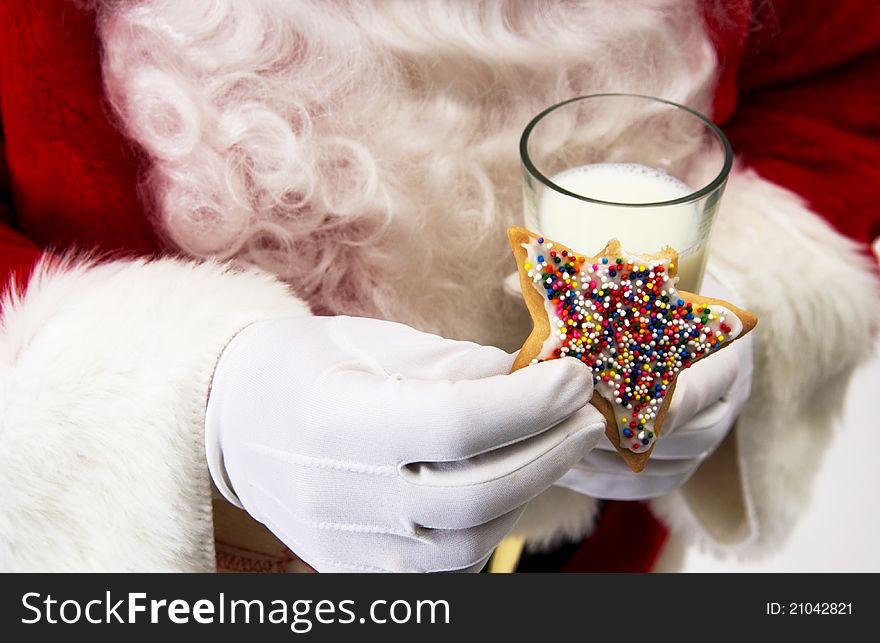 Santa holding cookie and glass of milk. Santa holding cookie and glass of milk