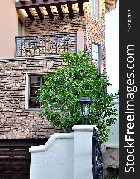 A small villa building detail, including wall and window, under lighting of sunset, shown as architecture geometric detail and color and texture under sunset lighting. A small villa building detail, including wall and window, under lighting of sunset, shown as architecture geometric detail and color and texture under sunset lighting.