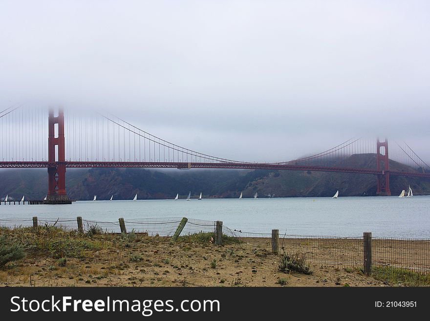 View of sailboats and the golden gate bridge on a foggy morning. View of sailboats and the golden gate bridge on a foggy morning