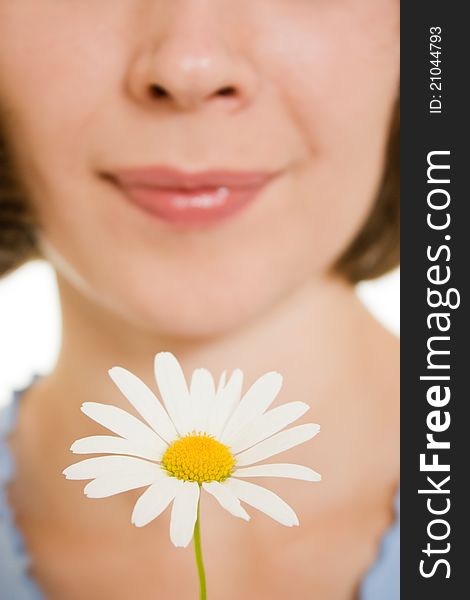 Girl smelling a flower on a white background. Girl smelling a flower on a white background.