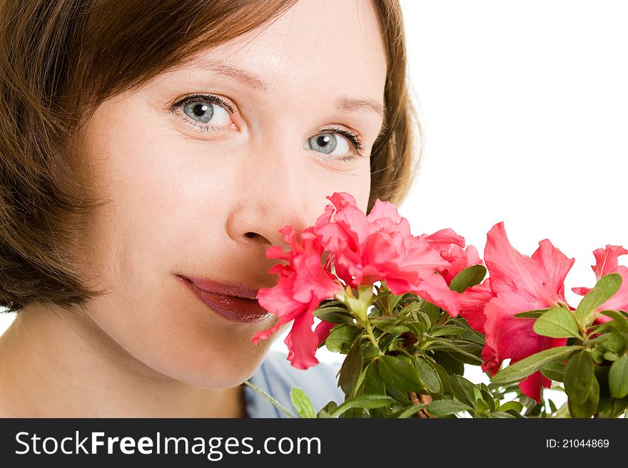 Girl smelling a flower on a white background. Girl smelling a flower on a white background.