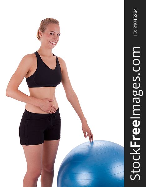 A young woman is doing exercises with a blue ball. A young woman is doing exercises with a blue ball