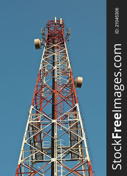 Telecommunication tower over a blue sky.