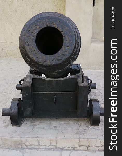 Frontal view of an ancient restored iron cannon in the Dubai fort. Frontal view of an ancient restored iron cannon in the Dubai fort