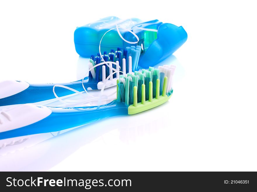 .Two Toothbrushes And Dental Floss Isolated