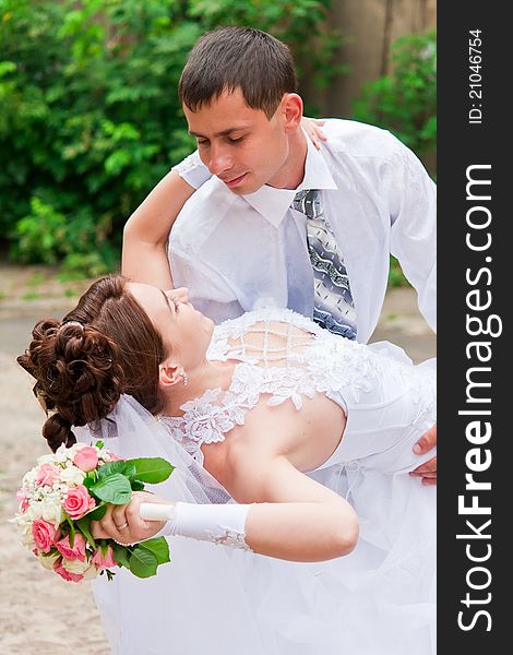 Bride and groom dancing outdoor