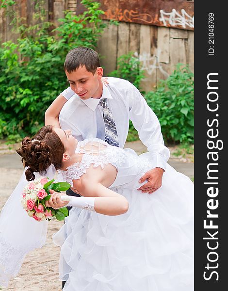 Bride and groom dancing outdoor